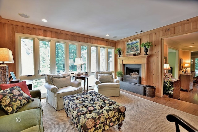 6528 Standing Boy Dr, Columbus, GA 31904 - living area featuring a fireplace with raised hearth, visible vents, wood walls, and wood finished floors