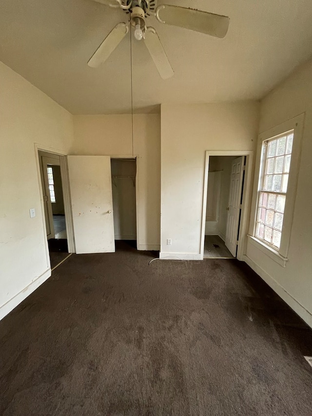 interior space featuring ceiling fan and dark colored carpet