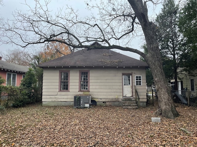 back of house with central AC unit