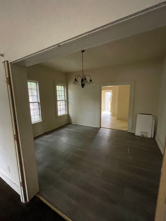 unfurnished dining area featuring a chandelier and plenty of natural light