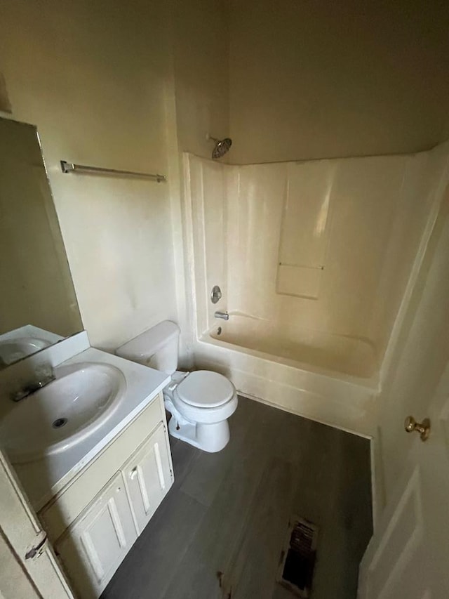 full bathroom with toilet, vanity, hardwood / wood-style floors, and tub / shower combination