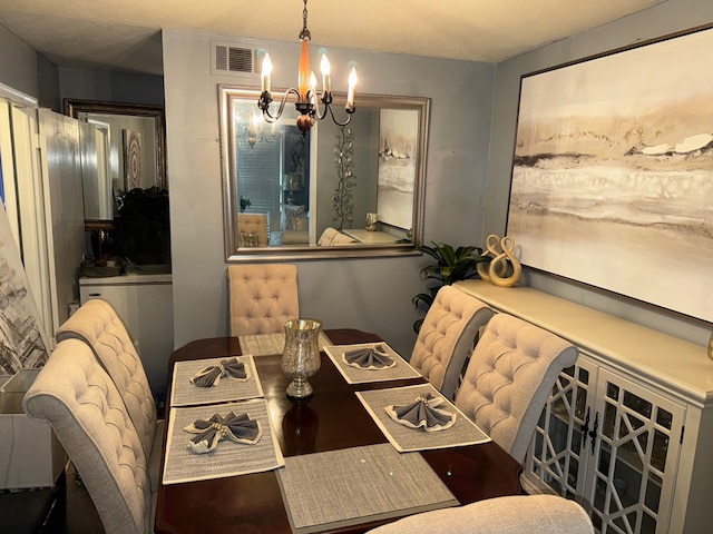 dining space featuring an inviting chandelier