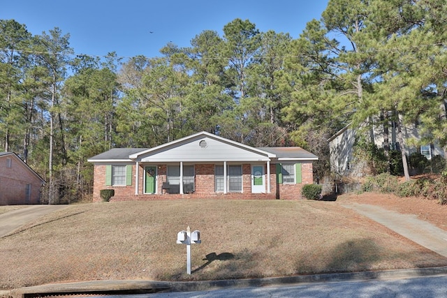 single story home with a porch and a front lawn