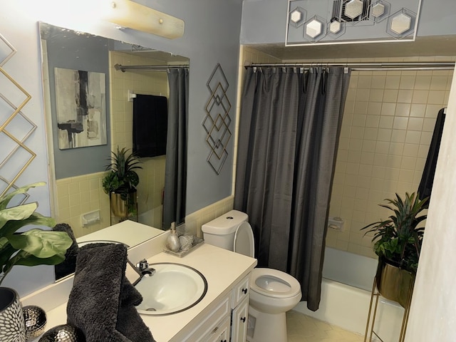 full bathroom featuring tile patterned flooring, vanity, toilet, and shower / bath combo with shower curtain