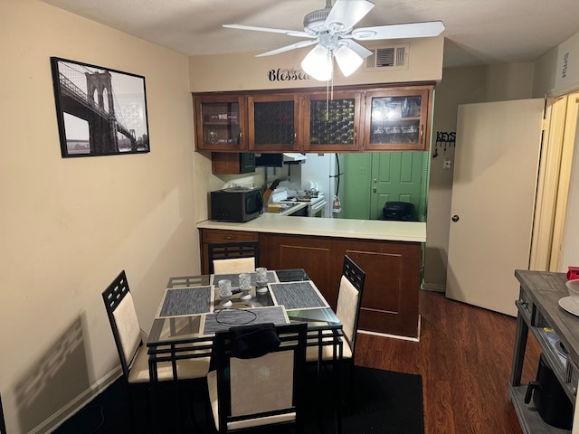 kitchen with white appliances, dark hardwood / wood-style floors, and ceiling fan