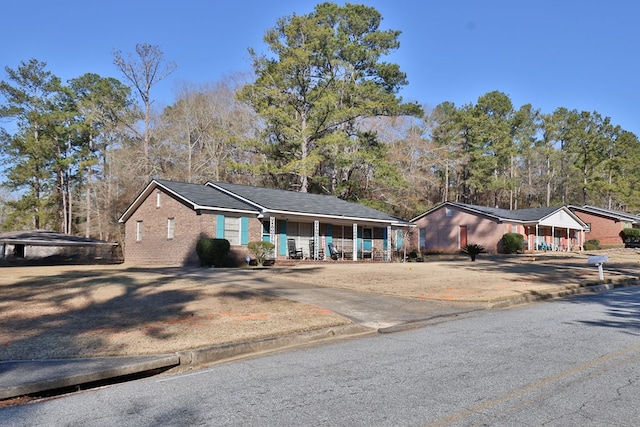 single story home with a porch