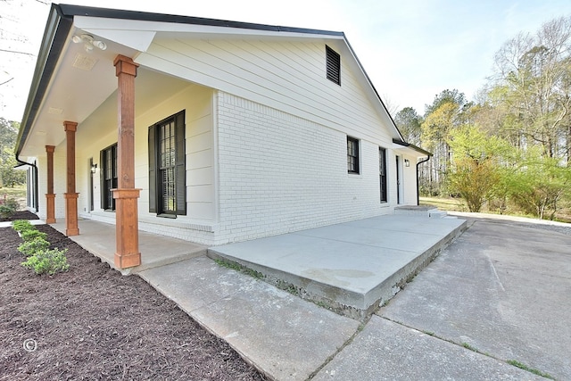 view of side of property with a porch