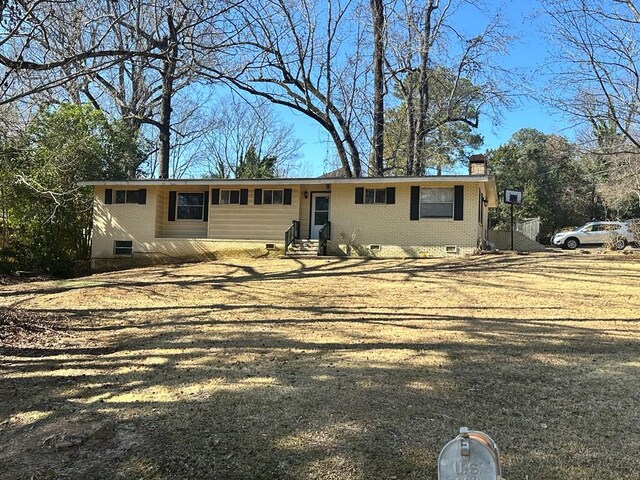 5926 Frazier Dr, Columbus, GA 31909 - view of side of home featuring an attached carport, concrete driveway, brick siding, and crawl space