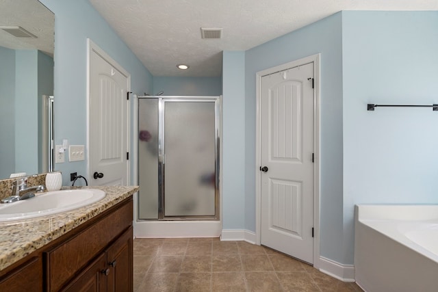 10 Cedarwood Ln, Phenix City, AL 36870 - bathroom with a shower stall, vanity, baseboards, a bath, and recessed lighting