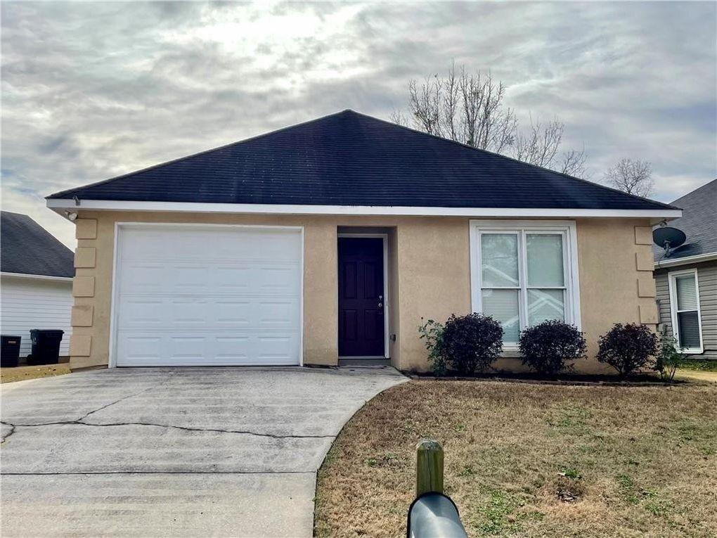 ranch-style house with concrete driveway, stucco siding, and roof with shingles