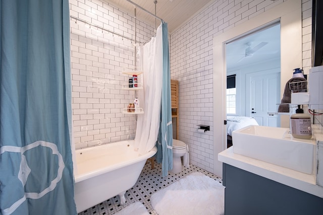 617 3rd Ave, Columbus, GA 31901 - bathroom featuring tile walls, shower / bathtub combination with curtain, vanity, tile patterned floors, and toilet