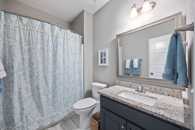 bathroom with toilet and vanity