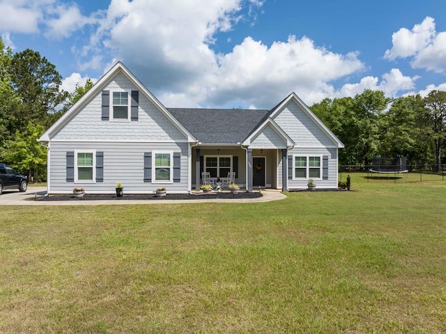 view of front facade with a trampoline, a front lawn, and a porch