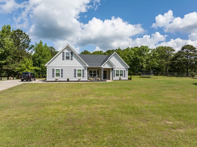 view of front of home with a trampoline and driveway