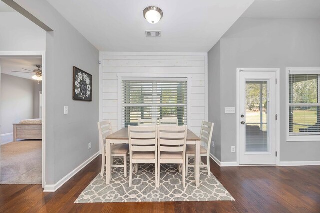 dining space featuring wood finished floors, baseboards, and ceiling fan