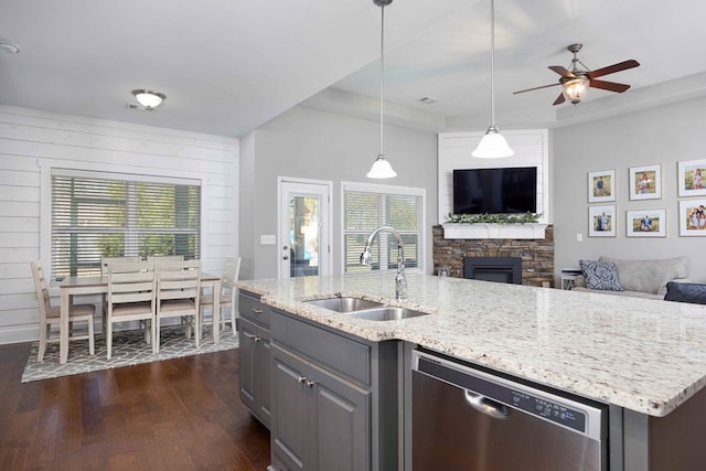 kitchen featuring dishwasher, a sink, open floor plan, and dark wood-style floors