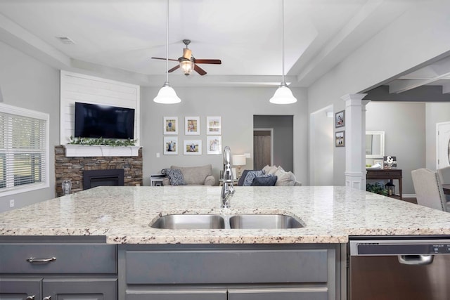 kitchen featuring dishwasher, open floor plan, a sink, and a ceiling fan