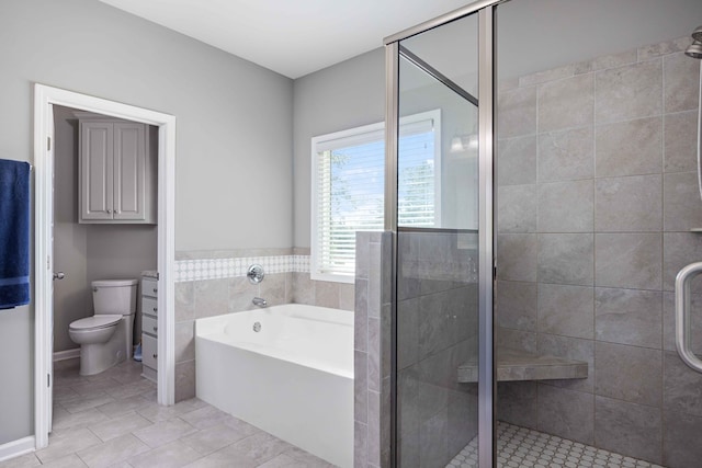 bathroom featuring a shower stall, a bath, tile patterned flooring, and toilet