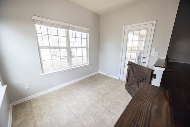 interior space featuring tile patterned floors and baseboards