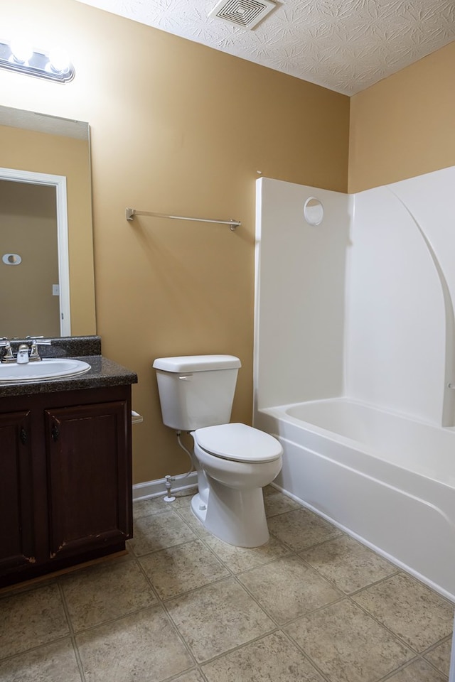 bathroom with vanity, visible vents, a textured ceiling, tile patterned floors, and toilet