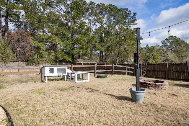 view of yard with an outbuilding, exterior structure, and a fenced backyard