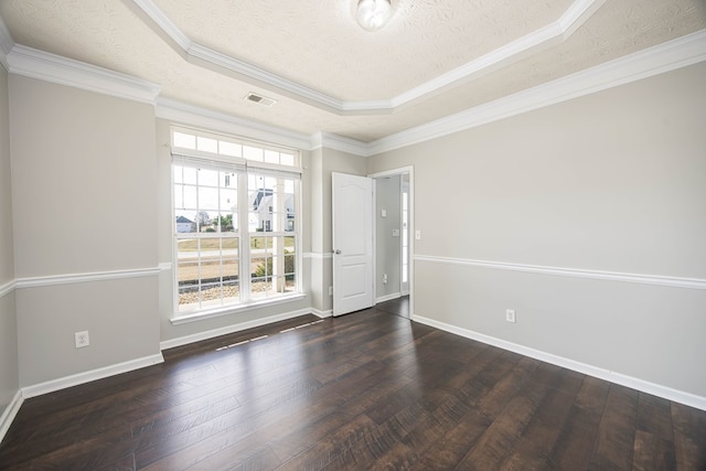 unfurnished room with a tray ceiling, baseboards, a textured ceiling, and hardwood / wood-style floors