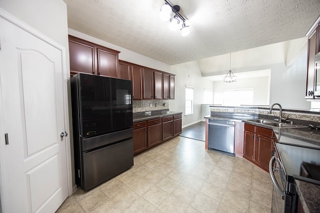 kitchen with a sink, dark countertops, backsplash, stainless steel appliances, and lofted ceiling