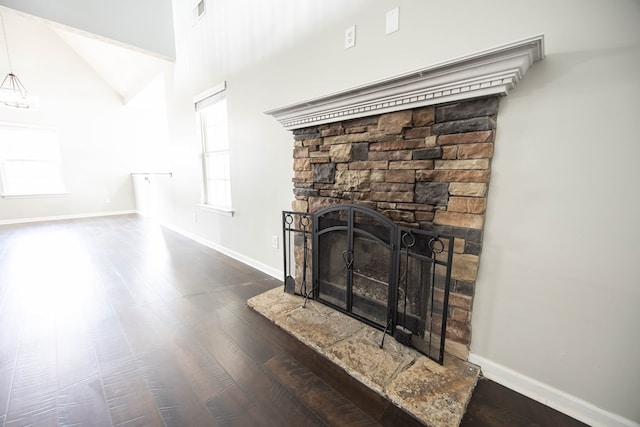 interior details with visible vents, baseboards, wood finished floors, and a fireplace