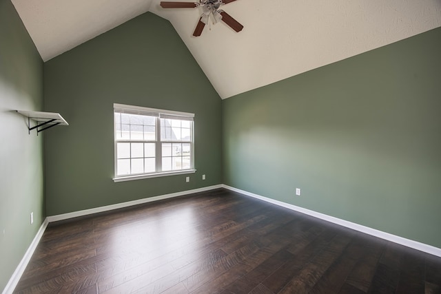 empty room featuring high vaulted ceiling, baseboards, a ceiling fan, and dark wood-style flooring