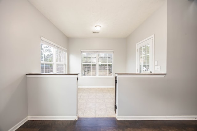 interior space with visible vents, baseboards, and a textured ceiling