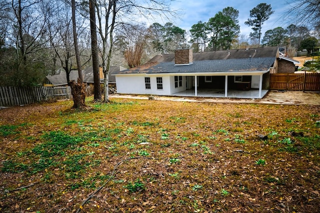 rear view of property with a patio area and a lawn