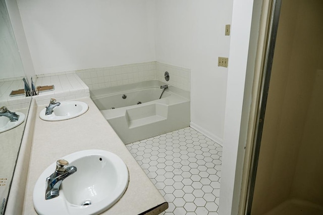 bathroom with vanity, tile patterned flooring, and a tub