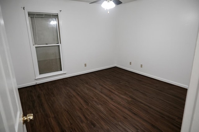 empty room featuring ceiling fan and dark hardwood / wood-style flooring