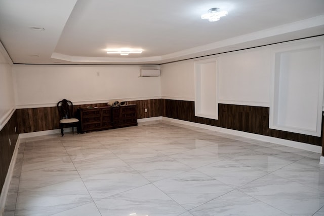 basement featuring an AC wall unit and wood walls