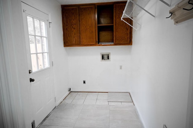 laundry room featuring cabinets, a healthy amount of sunlight, hookup for an electric dryer, and hookup for a washing machine