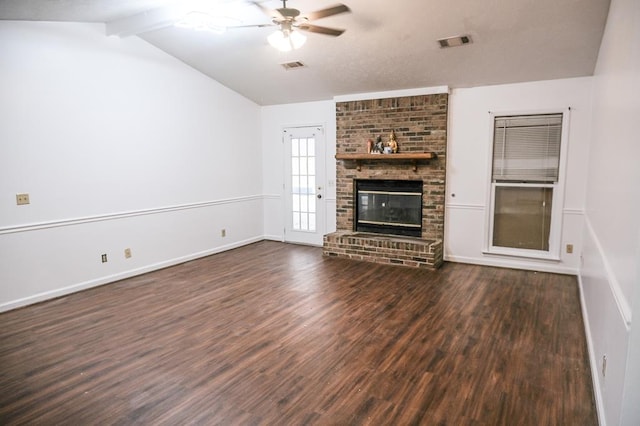 unfurnished living room featuring vaulted ceiling with beams, a fireplace, dark hardwood / wood-style floors, and ceiling fan