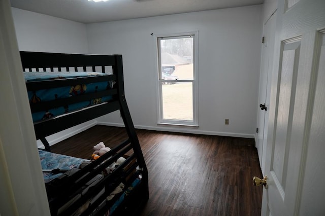 bedroom with dark hardwood / wood-style flooring