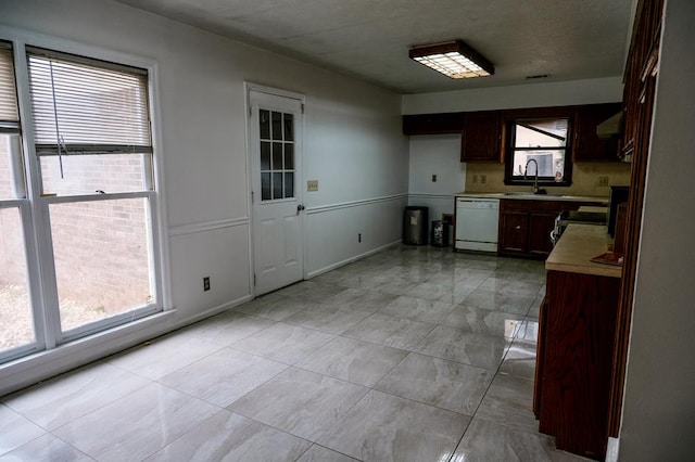 kitchen featuring sink, a wealth of natural light, stainless steel range oven, and dishwasher