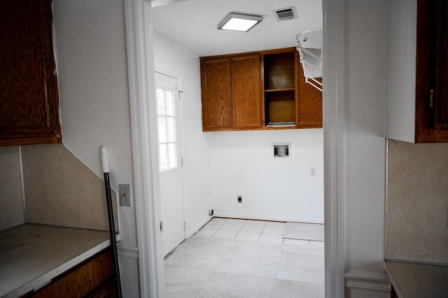 washroom featuring cabinets, washer hookup, and electric dryer hookup