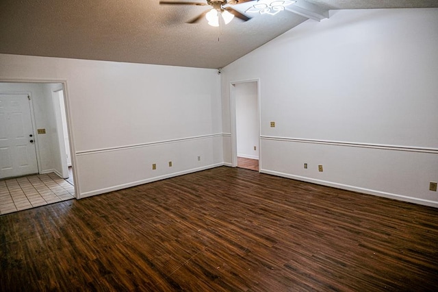 empty room with dark wood-type flooring, ceiling fan, lofted ceiling with beams, and a textured ceiling