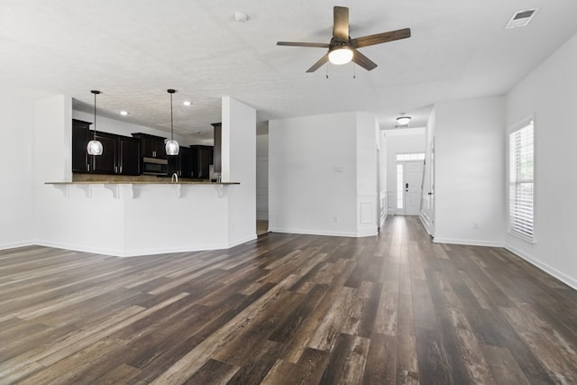 unfurnished living room with dark wood-style floors, a ceiling fan, baseboards, and recessed lighting