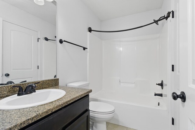 full bathroom with toilet, vanity,  shower combination, and tile patterned floors