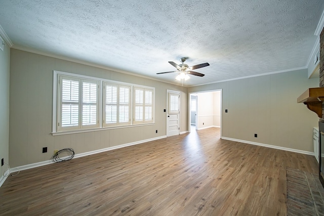 2310 Nottingham Dr, Columbus, GA 31904 - unfurnished living room with wood finished floors, a textured ceiling, a ceiling fan, baseboards, and ornamental molding