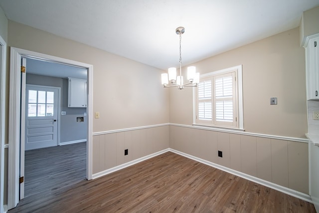 2310 Nottingham Dr, Columbus, GA 31904 - empty room featuring dark wood-type flooring, a wainscoted wall, and a chandelier