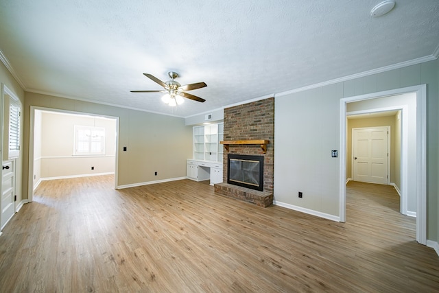 2310 Nottingham Dr, Columbus, GA 31904 - unfurnished living room featuring a ceiling fan, light wood-style flooring, a fireplace, ornamental molding, and baseboards