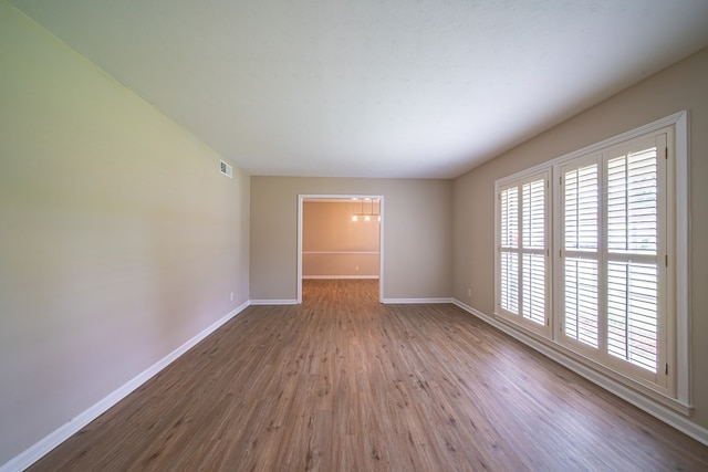 2310 Nottingham Dr, Columbus, GA 31904 - spare room featuring wood finished floors, baseboards, and a chandelier