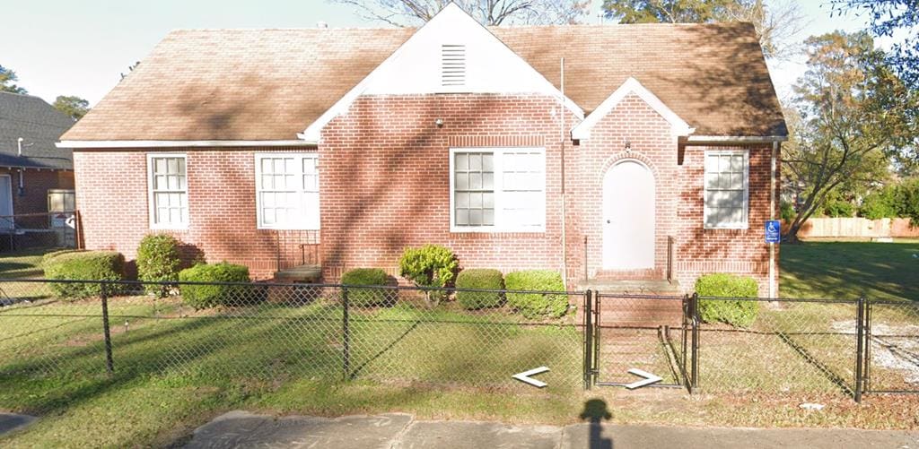 202 S Maple St, Tuskegee, AL 36083 - view of front of home featuring brick siding and a gate