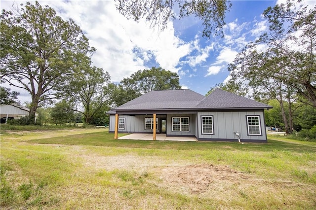 rear view of property with a patio and a lawn