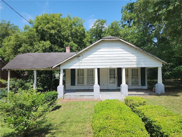 220 15th Ave S, Phenix City, AL 36869 - bungalow-style house featuring covered porch, a front lawn, and a chimney