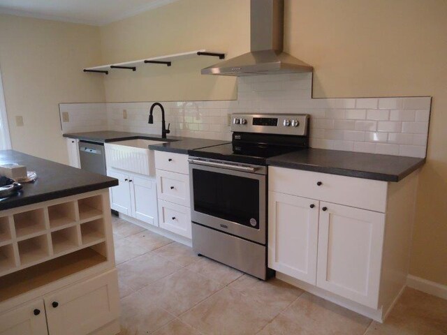 kitchen featuring white cabinets, backsplash, stainless steel appliances, and extractor fan